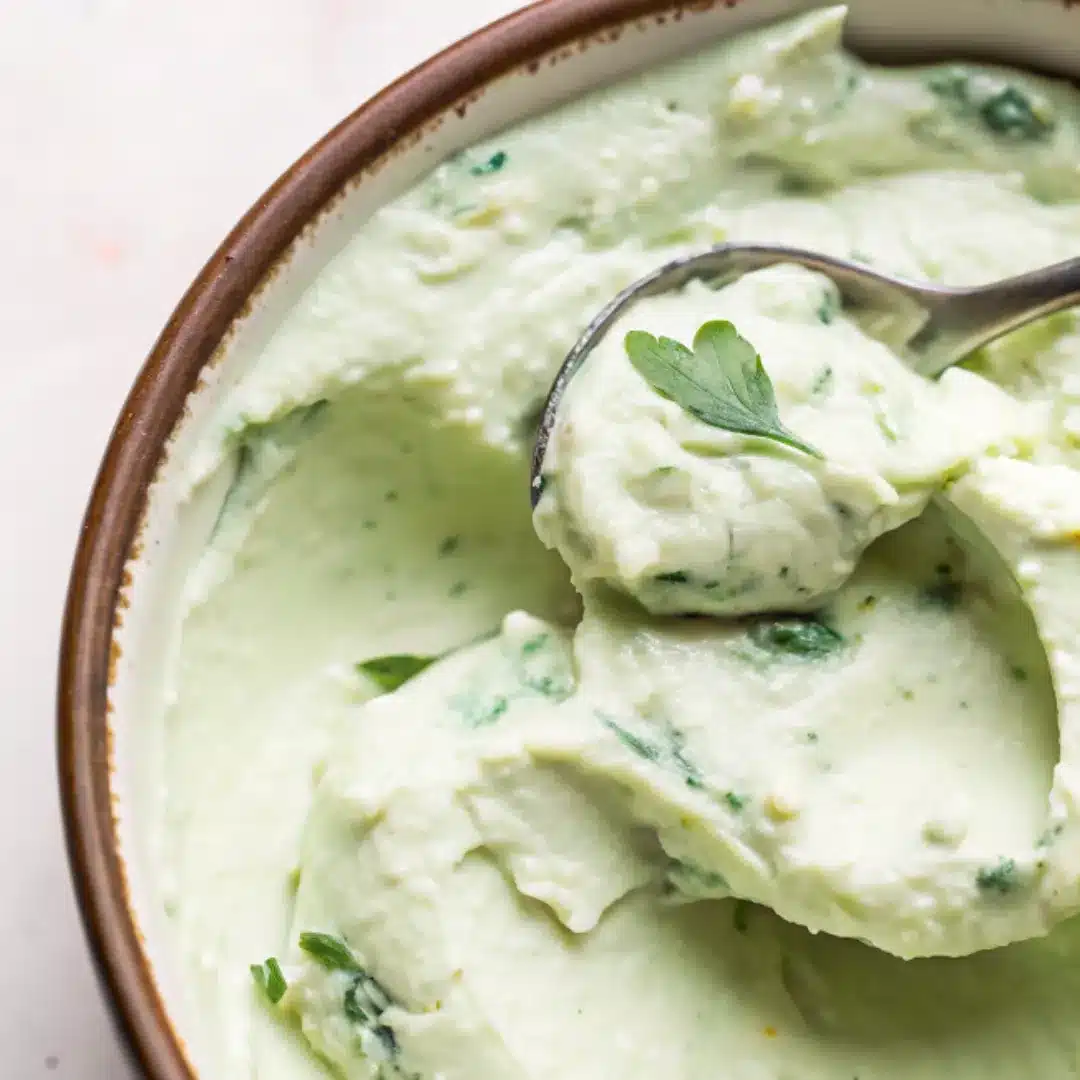 Jalapeño Cream Cheese – Spicy, Smooth, and Flavor-Packed Bowl of whipped jalapeño cream cheese with herbs, scooped with a spoon
