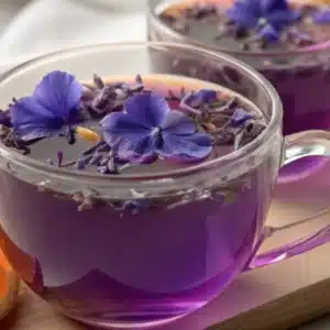 Brazilian Mounjaro Recipe: Natural 3-Ingredient Detox Drink People Swear By 10 Close-up of Brazilian Mounjaro recipe tea with butterfly pea flowers in a glass cup