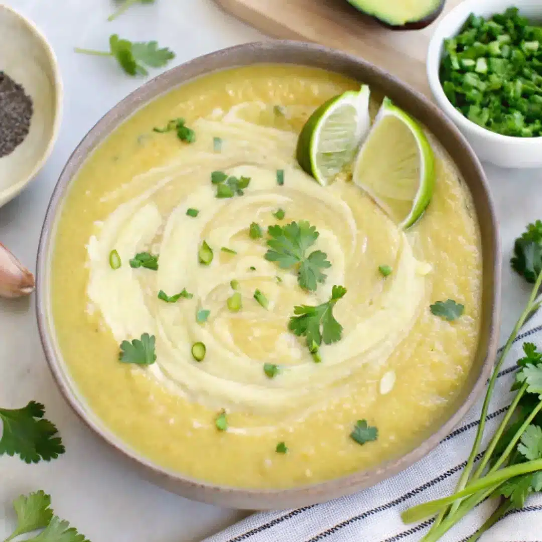 Cream of Jalapeño Soup – Smooth, Spicy, and Comforting Cream of jalapeño soup garnished with cilantro, lime wedges, and a swirl of cream