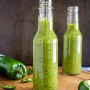 Jalapeno Hot Sauce Recipe That’s Fresh, Spicy, and Easy to Make 13 Bottled jalapeno hot sauce displayed with fresh peppers