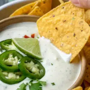 Jalapeño Ranch Dip – The Best Spicy & Creamy Party Favorite 7 jalapeño ranch dip with lime and jalapeño slices served with tortilla chips