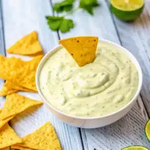 Chuys Jalapeno Ranch Recipe – The Best Creamy Copycat Ever 6 Bowl of herby green sauce with tortilla chips on the side